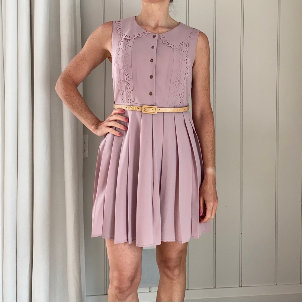 Adorable pink mini dress. Laser cut designs and pleated skirt. Size S/M
